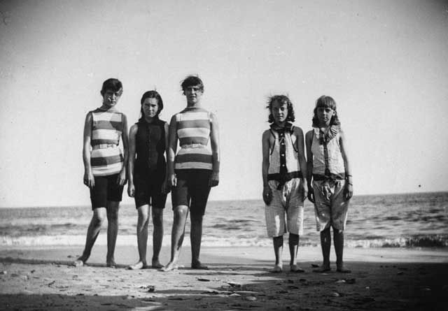 "Five girls who will be competing in a swimming match posing by the shoreline at Coney Island, Brooklyn, NY." August 27, 1887
